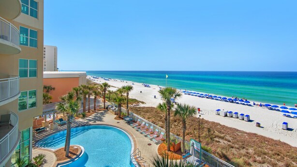 A resort with a pool, beach, and ocean view. - 302 -Luxury Gulf-Front Condo | 3 Bedrooms | Sleeps 8+ Free Beach Chairs! (Panama City Beach)