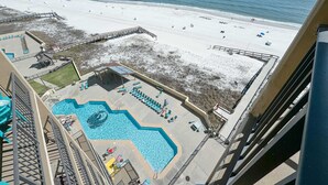 A hotel with a pool and beach access.