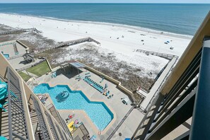A hotel with a pool and beach access.