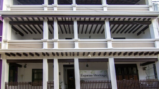 Un bâtiment à deux étages doté d’un balcon et d’une enseigne indiquant « Esparan Heritage ».