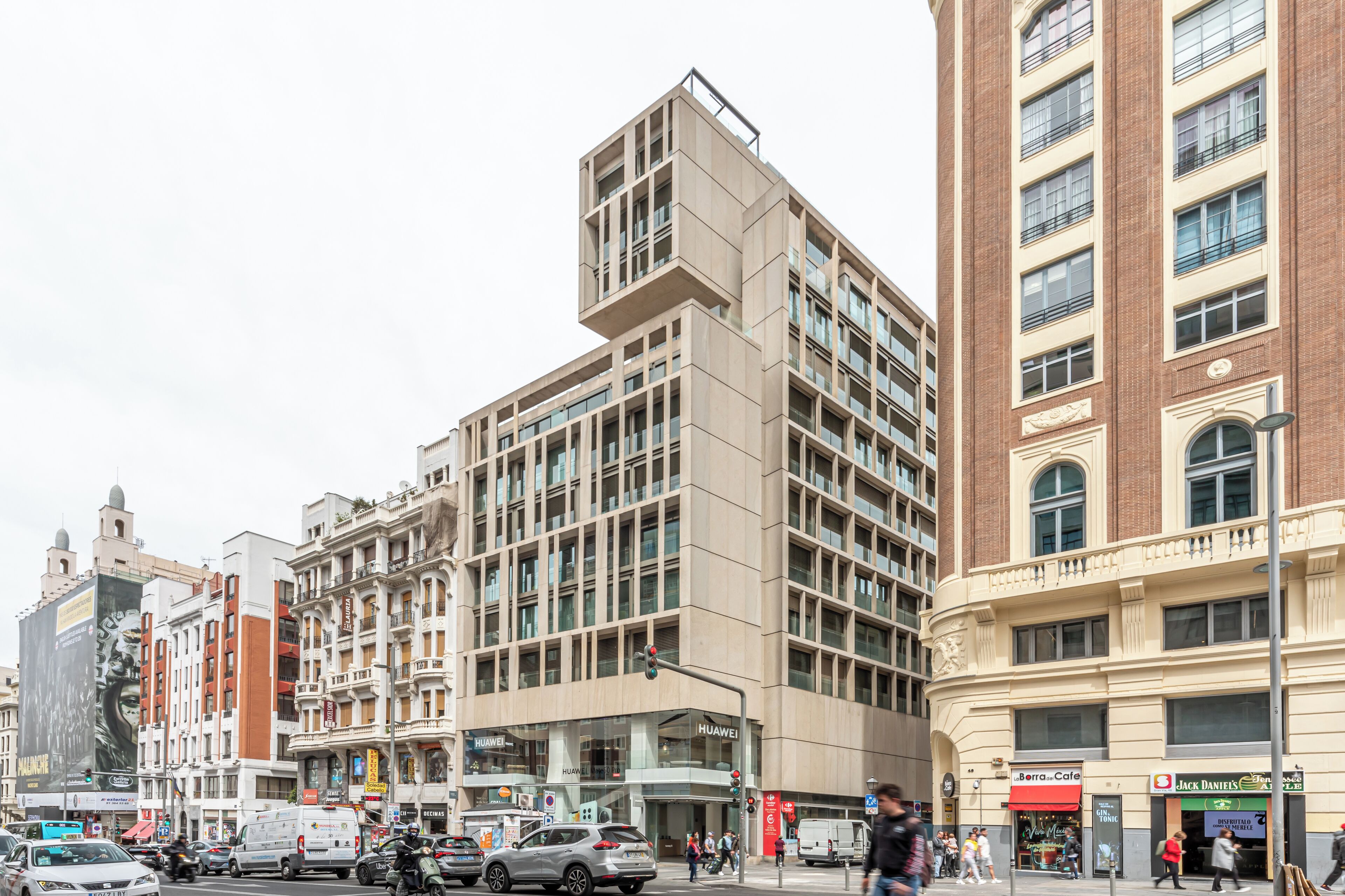 A multi-story building with a modern design, featuring large windows and a mix of brick and concrete facades.