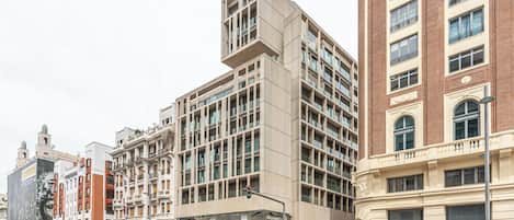 A multi-story building with a modern design, featuring large windows and a mix of brick and concrete facades.