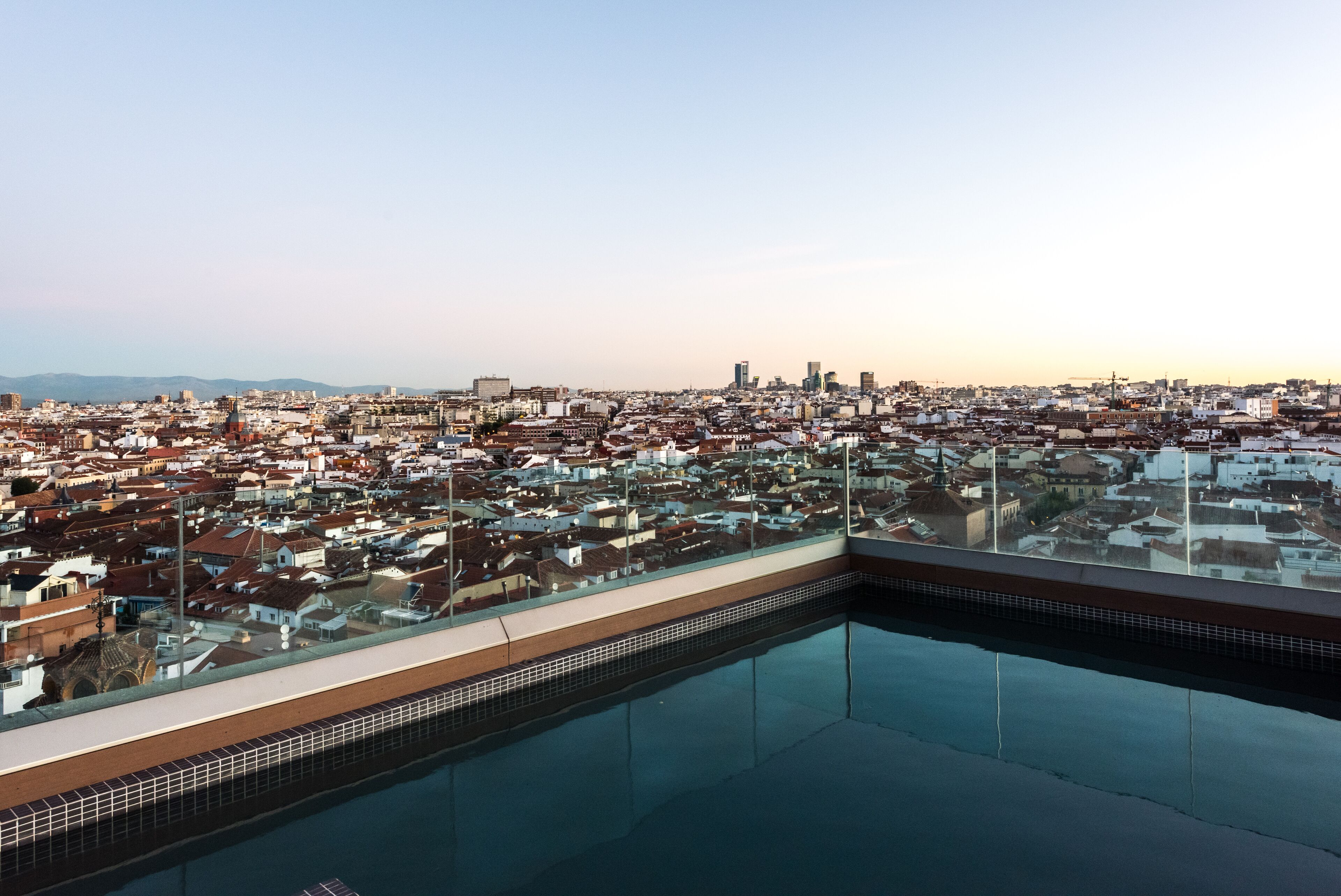 A rooftop pool with a cityscape view.