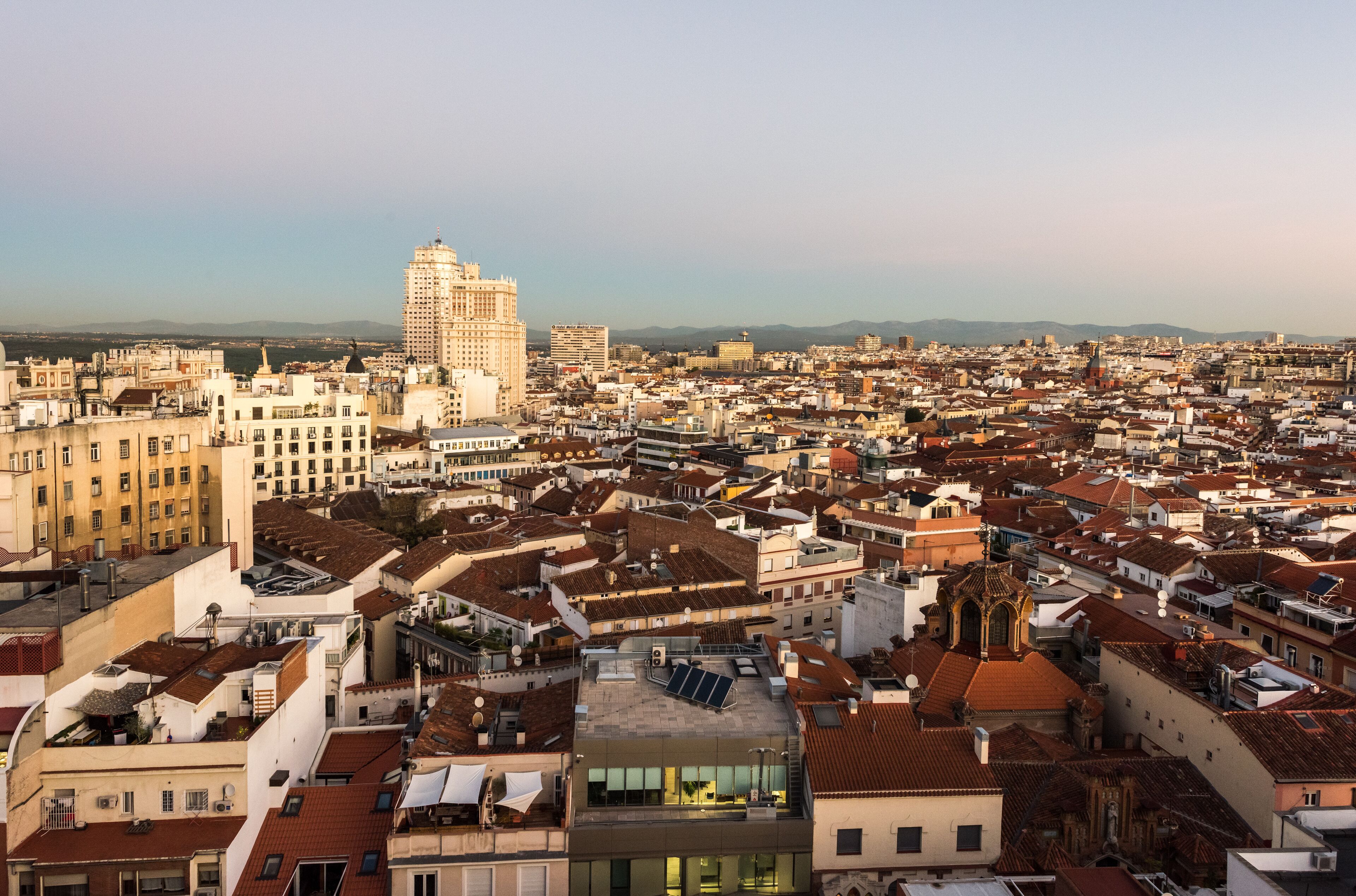 A cityscape with a prominent historic building and a modern skyscraper.