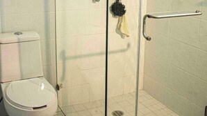 A glass-enclosed shower with a glass door, a toilet, and a towel rack. - Enjoy your stay right  in the heart of Morelia (Morelia)