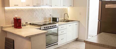 Coffee/tea maker, toaster, coffee grinder, cookware/dishes/utensils