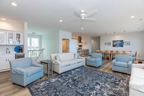 A modern living room with a sofa, chairs, a coffee table, and a blue patterned rug. - Shellebration - Luxurious 8 BR, 8 BA Oceanfront Home - Pool & Elevator! (Surf City)