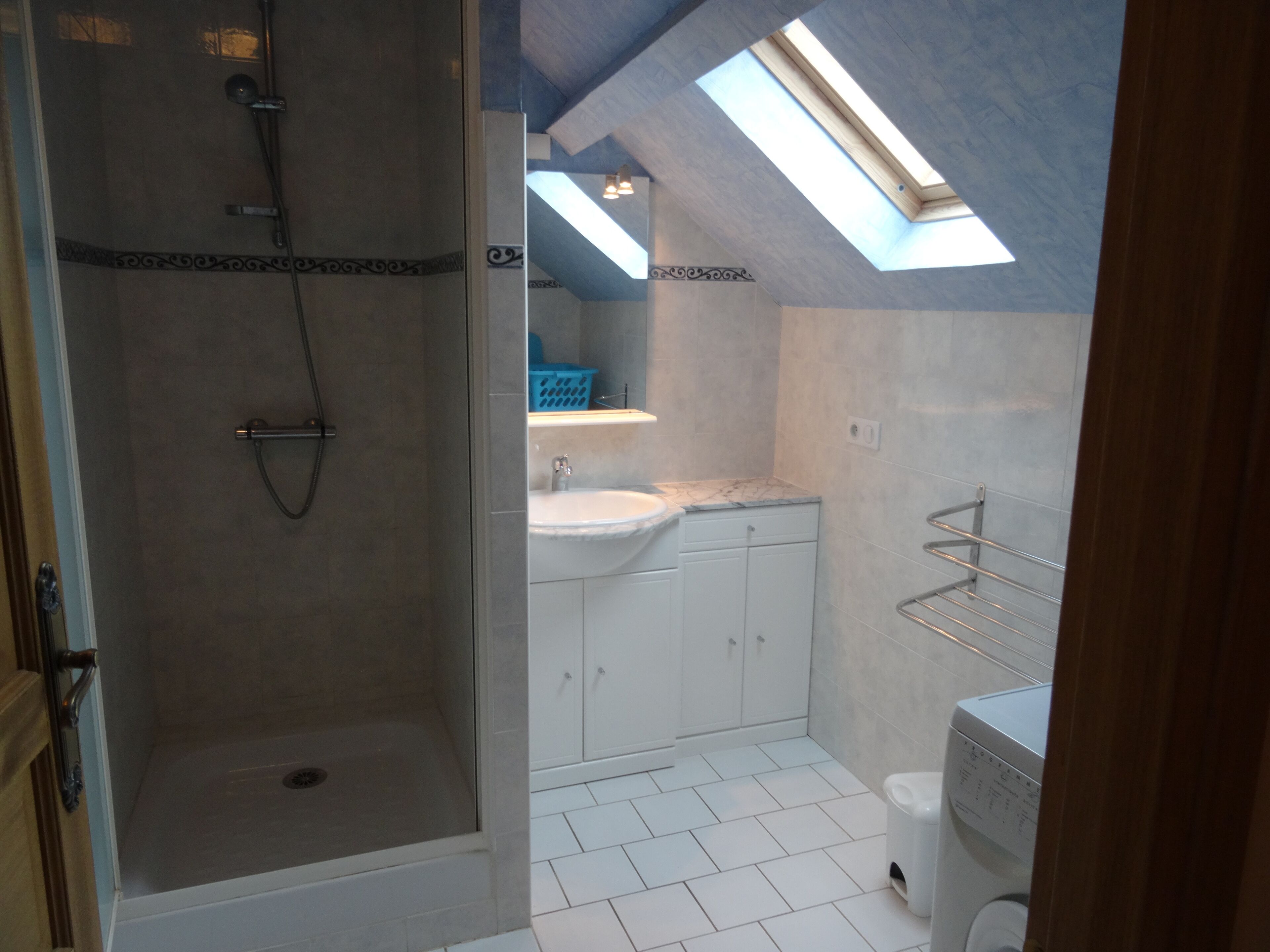 A bathroom with a shower, sink, and toilet.