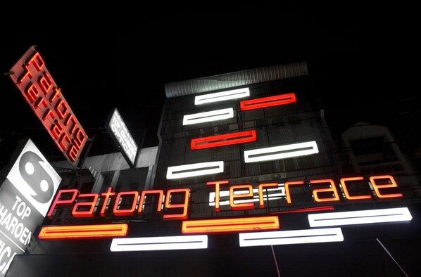 A building with illuminated signage reading "Patong Terrace." - Patong Terrace Boutique Hotel (Patong)