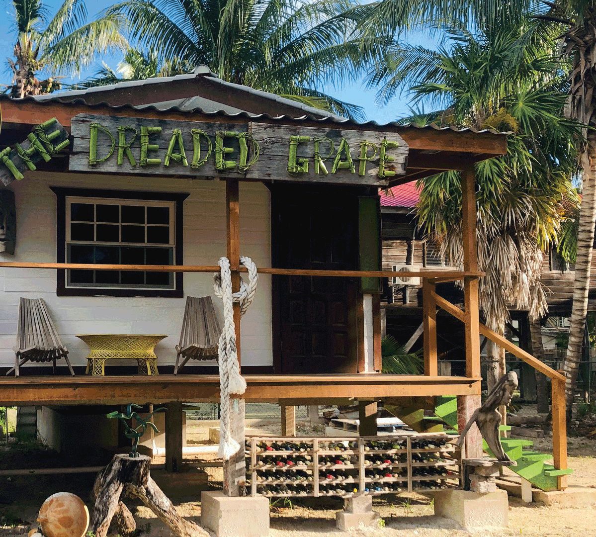 Une structure en bois dotée d’un balcon, d’une enseigne indiquant « Le Bosquet rêvé » et d’un porte-bouteilles à vin à l’extérieur.