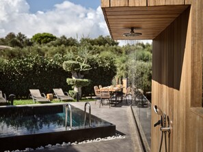 A pool with a wooden pergola overhead, surrounded by greenery and outdoor furniture. - Alexandros Deluxe SeaView Villa, with Heated Pool (Zakynthos)