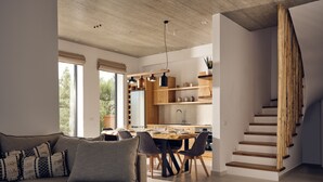Un salon moderne avec un canapé, un coin repas et un escalier en bois.