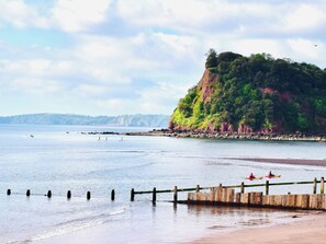 A beach with a wooden pier and kayaks. - 3 bedroom accommodation in Teignmouth (Teignmouth)