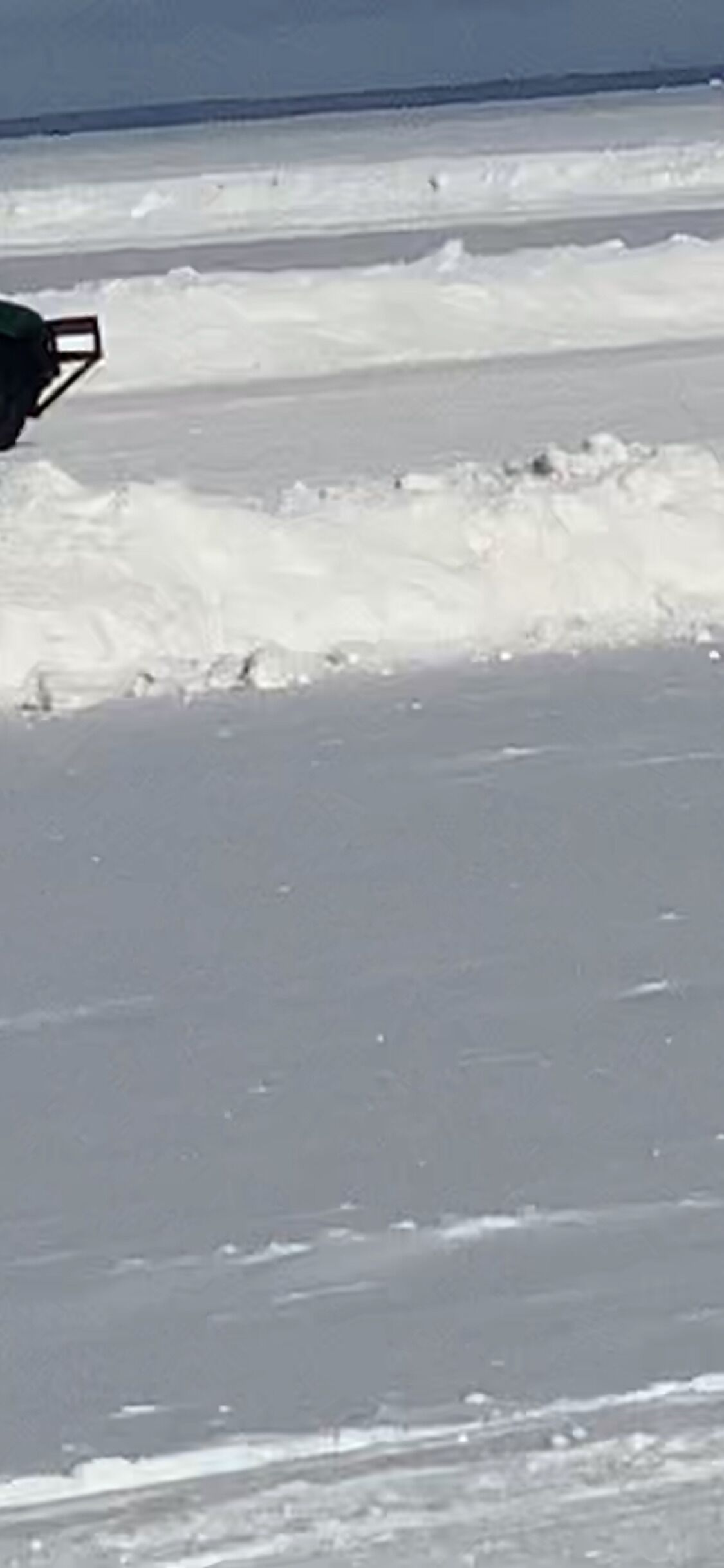 A snowy beach with a clear sky.