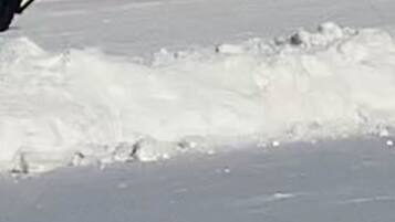 A snowy beach with a clear sky.