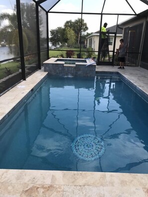 Outdoor pool, a heated pool - Beautiful 3 bed 3 bath canal home with large lanai, heated pool and hot tub. (Cape Coral)