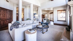 A spacious living room with a large sofa, a coffee table, and a wooden cabinet. - Hyatt at the Canyons by Park City Vacations (Park City)