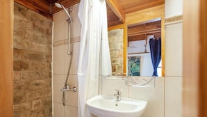 A bathroom with a shower, a sink, and a mirror. - B and B Saules Namai (Vilnius)