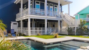 A two-story building with a balcony and a pool area.