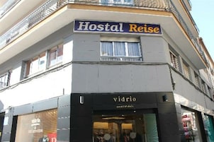 A building with a sign reading "Hostal Reise" and a shop named "vidrio" below it.