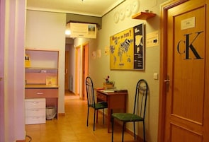 A hallway with a desk, chairs, and a door labeled 'cK'.