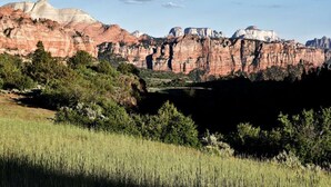 A natural landscape with red rock formations and green vegetation. - Bunkhouse 8A In Tranquil Environment (La Verkin)