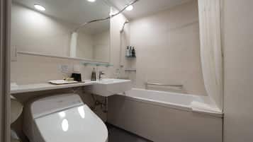 Un baño moderno con inodoro, lavamanos y bañera.