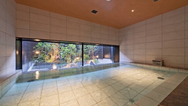 A spacious indoor area with a large window, a tiled floor, and a small water feature. - hotel around TAKAYAMA, an Ascend Collection Hotel (Takayama)