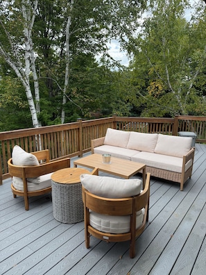 A wooden deck with a sofa, chairs, and a coffee table. - Serene mountain escape with beautiful views and a hot tub (Jefferson)