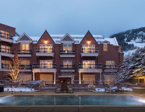 Experience the charm of this historic hotel, featuring a central entrance and spacious balconies with black railings.