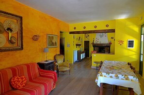 TV, fireplace - Villa delle Camelie A: A characteristic and welcoming apartment that covers the entire ground floor of a villa surrounded by the greenery, with Free WI-FI. (San Marcello Piteglio)