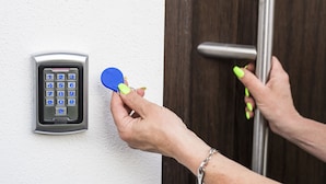 A person using a keypad lock and a blue key fob to operate a door. - Guesthouse Urša (Preddvor)