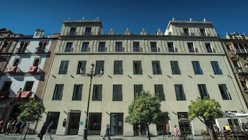 Stunning classical architecture with symmetrical windows and decorative elements adorns this urban building.