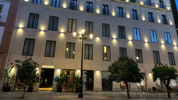 A multi-story hotel with a classic architectural style, featuring evenly spaced windows and a central entrance. - SOHO BOUTIQUE CATEDRAL (Seville)
