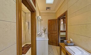 Bathtub, towels, shampoo, toilet paper