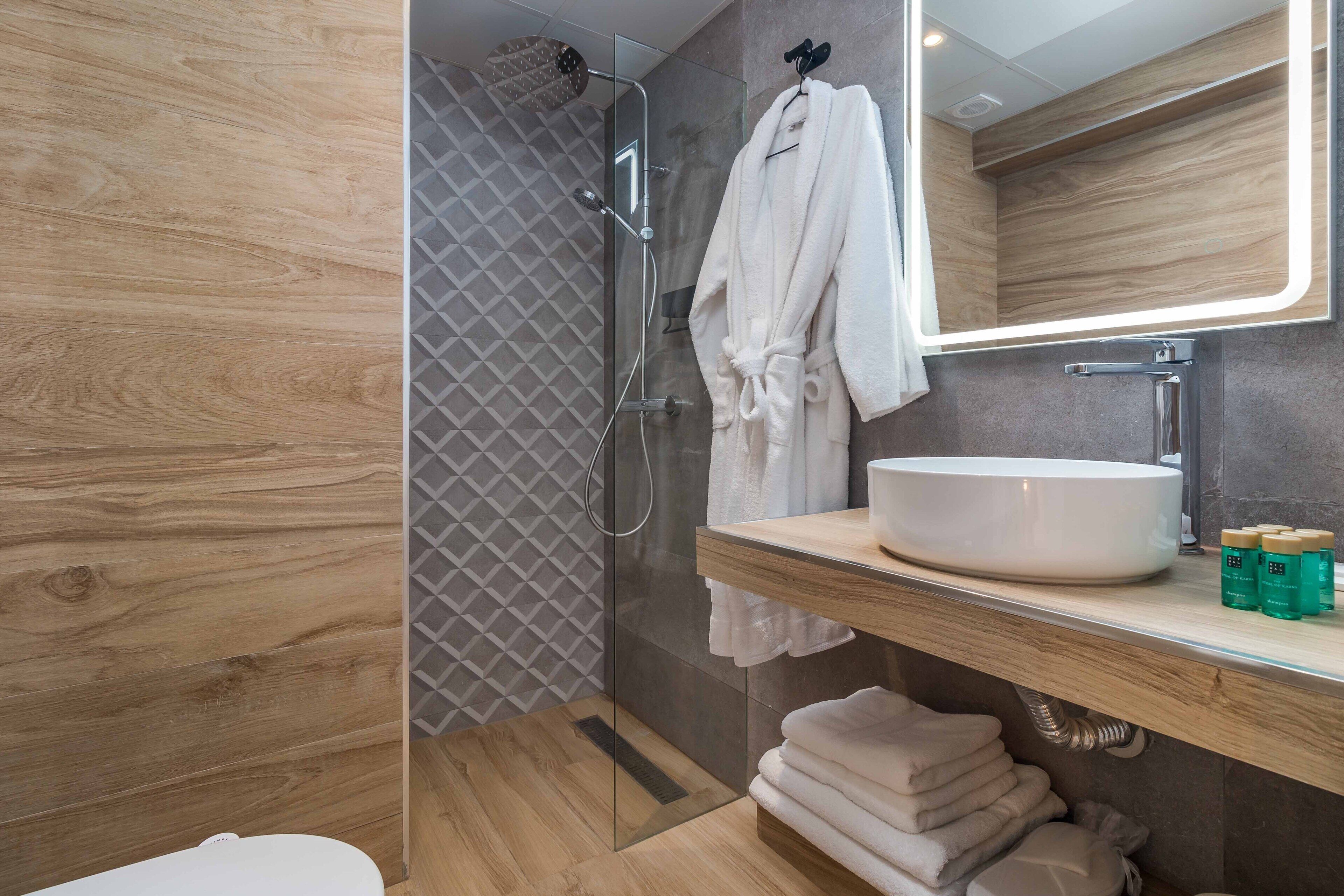 superior studio suite | bathroom | shower, free toiletries, hair dryer, towels