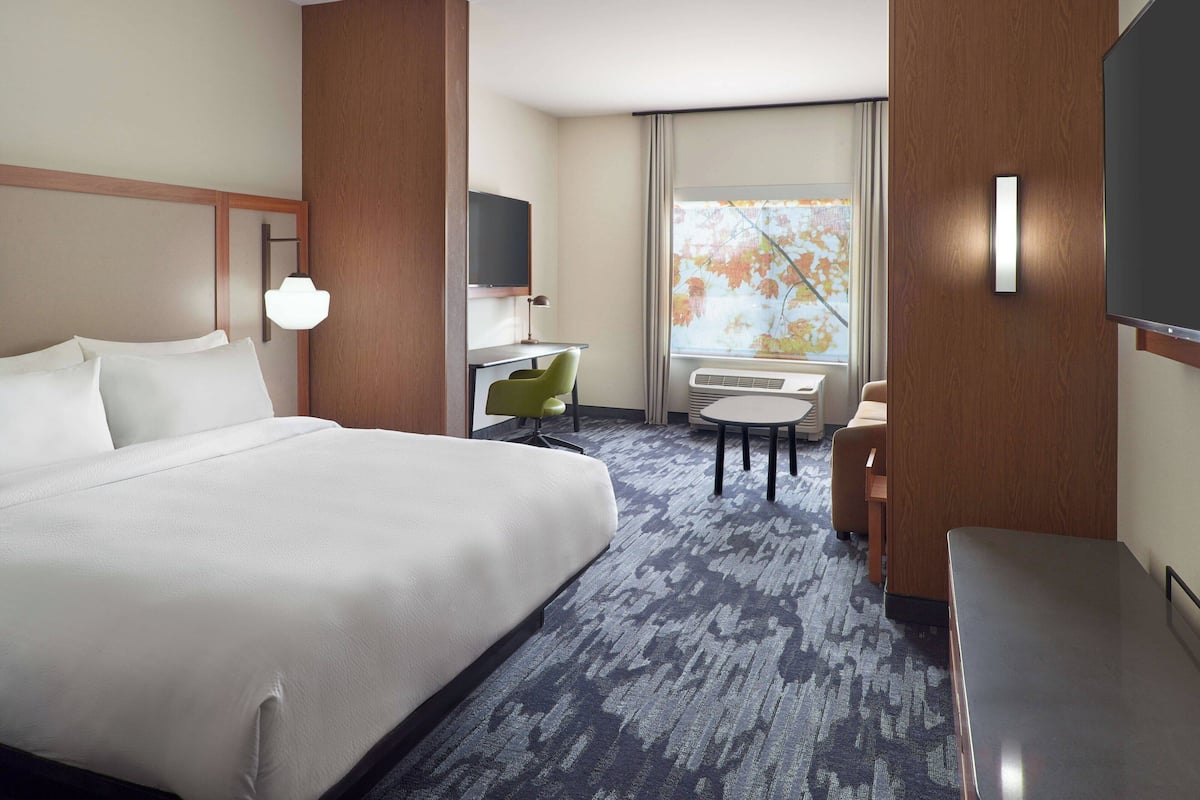 hypo-allergenic bedding, desk, laptop workspace, blackout curtains