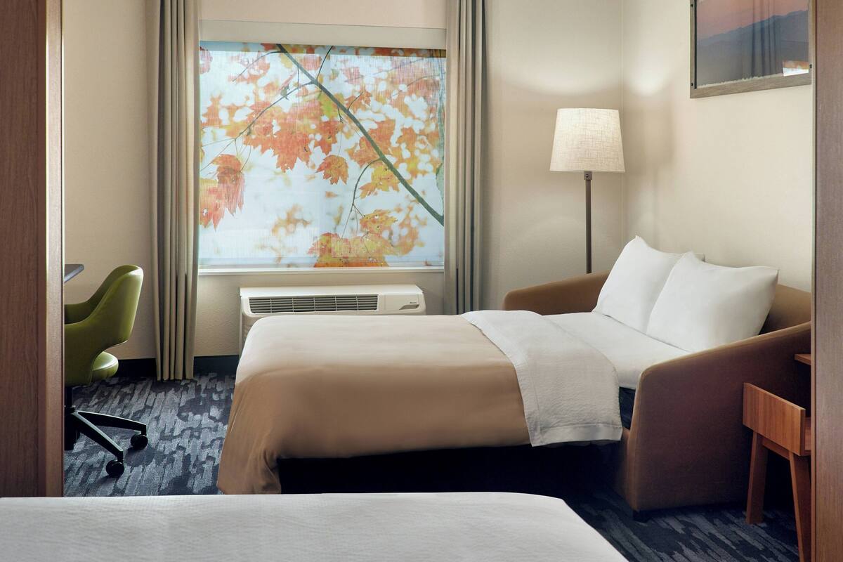 hypo-allergenic bedding, desk, laptop workspace, blackout curtains