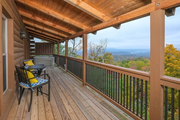 A wooden deck with a view of a mountainous landscape.