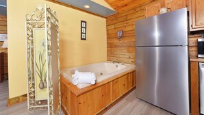 A modern kitchen with a wooden interior, a stainless steel refrigerator, and a wooden cabinet.