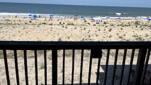 A beach with umbrellas, people, and a view of the ocean. - Beachfront Baby💛 Beautiful & New!🌟The only way to stay @ the beach❣️Spacious  (Dewey Beach)