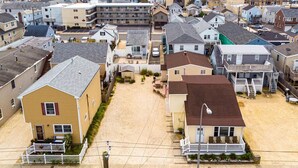 A residential area with houses, a parking lot, and a street. - Upscale and Cozy Ocean Block Home w/ Free Parking, BBQ, Patio, Outdoor Shower (Seaside heights)