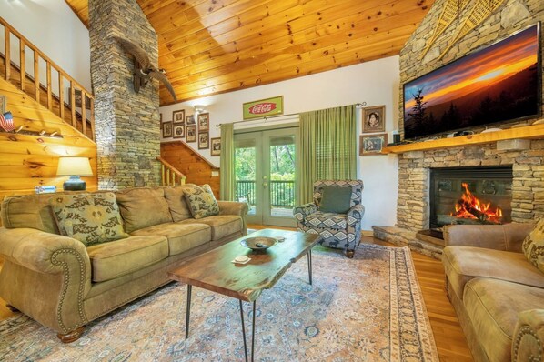 Télévision, cheminée, lecteur de DVD, baby-foot