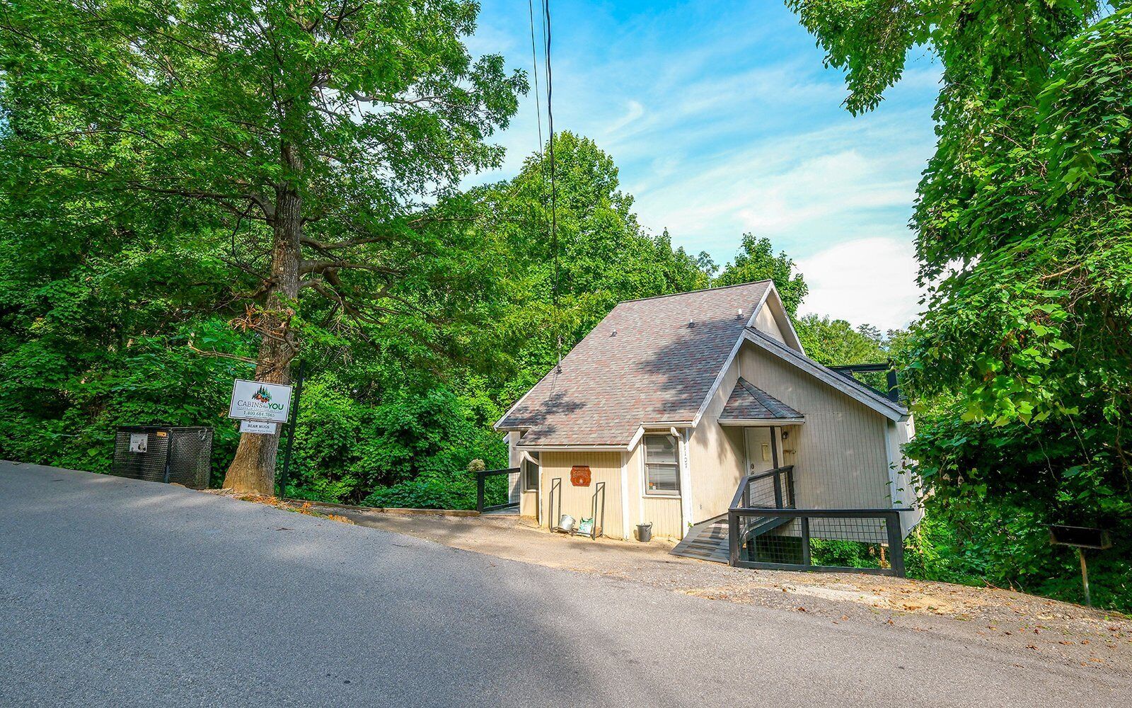 A small, single-story building with a sloped roof, a front door, and a small porch area.