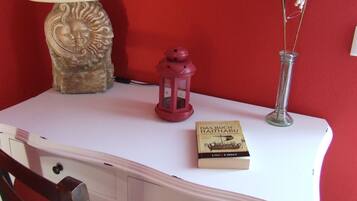 A white table with a book titled "Das Buch Haithabu" and a red lantern.