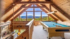 A wooden interior with a pool table and a scenic mountain view. - Peak A View - Spectacular Mountain View, Rec Room Loft, Relaxing Hot Tub (Sevierville)
