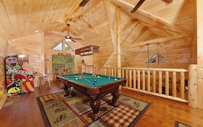 A wooden interior with a pool table, a mural, and a view of the outdoors. - Charlie Brown's Cabin・Hot Tub・Game Room・Community Pool + Mini Golf (Sevierville)