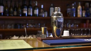 A bar area with a cocktail shaker, a small glass, and a menu on the counter. - Orovacanze Hotel Villa Emma (Canazei)