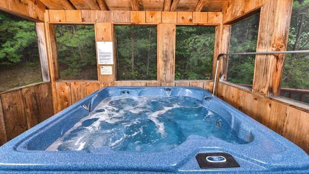 A wooden cabin with a hot tub. - Think a Little Less - Air Hockey, Gas Fireplace (Sevierville)