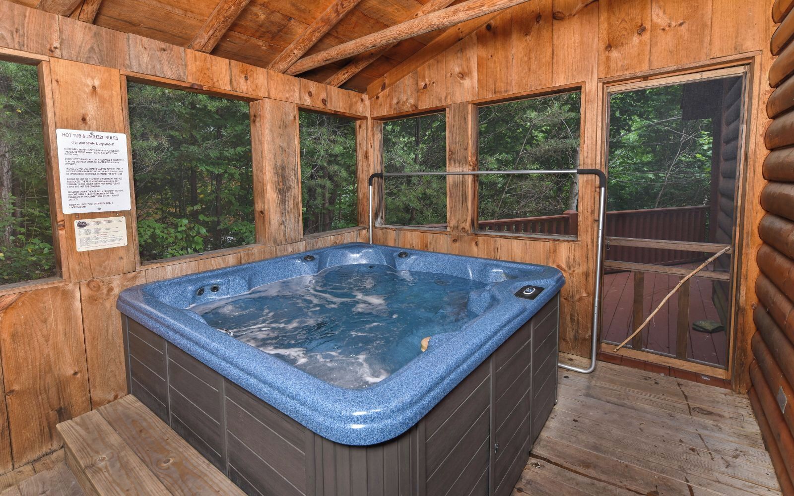A wooden cabin with a hot tub.